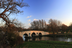 Winter sunset, Stone bridge over the river Nene, Ferry Meadows Park, Peterborough, Cambridgeshire; England; UK,