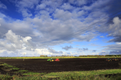 Tractors ploughing in fields