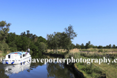 Boat on the river Ant passing How Hill Windpump