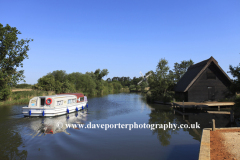 Boat on the river Ant passing How Hill Windpump