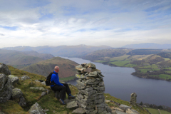 Walker at the Summit Cairn of Bonscale Fell