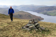 Walker at the Summit Cairn of Bonscale Fell