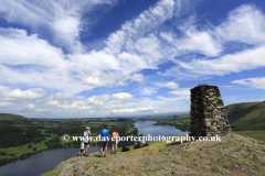 Walkers at Hallin fell summit cairn, Ullswater