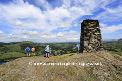 Walkers at Hallin fell summit cairn, Ullswater