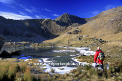 Walker at Mount Snowdon reflected in Llyn Llydaw