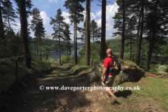 Walker on Win Hill overlooking Ladybower reservoir