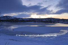 Sunrise over the frozen Kollafjordur lake