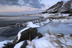 Sunrise over the frozen Kollafjordur lake