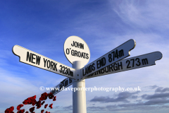 Remembrance Poppies at the Milepost at John O Groats village, North coast of Caithness, Scotland, UK